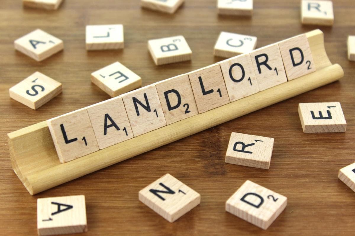 Scrabble game pieces with the words Landlord